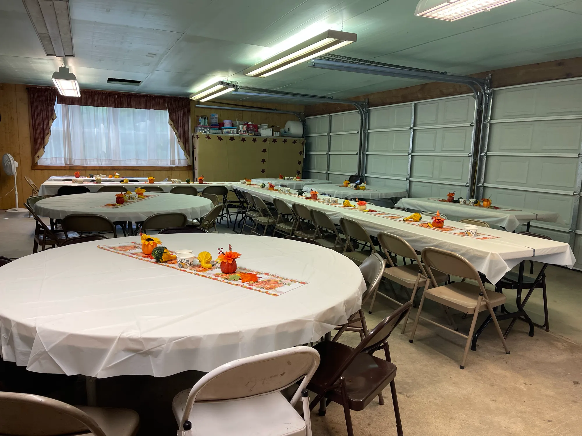 Lodge hall set with round and long tables and fall centerpieces